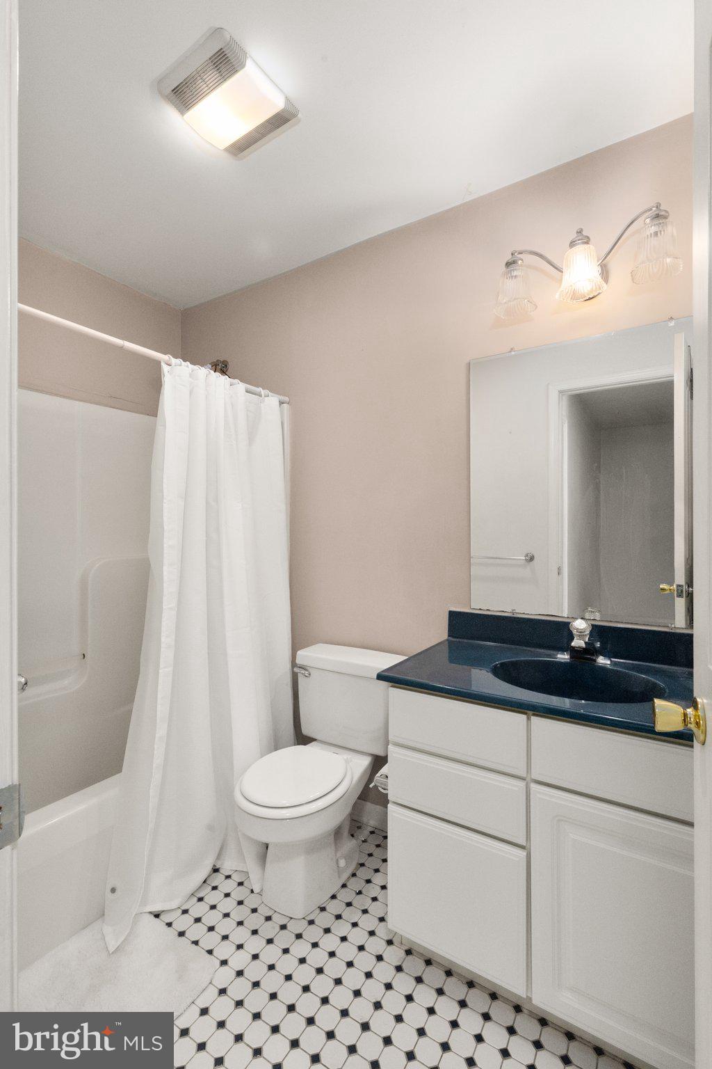 40 Stubb Road Rising Sun, MD 21911 - Photo 17 of 39 a bathroom with a granite countertop sink a toilet a mirror a lamp a vanity and shower