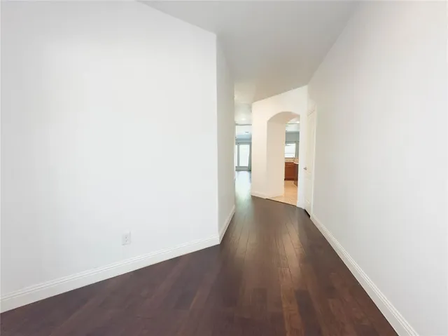 a view of a room with wooden floor
