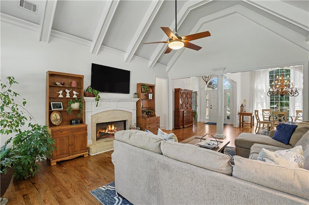 537 Old Collins Road Hoschton, GA 30548 - Photo 12 of 42 a living room with furniture a flat screen tv and a fireplace