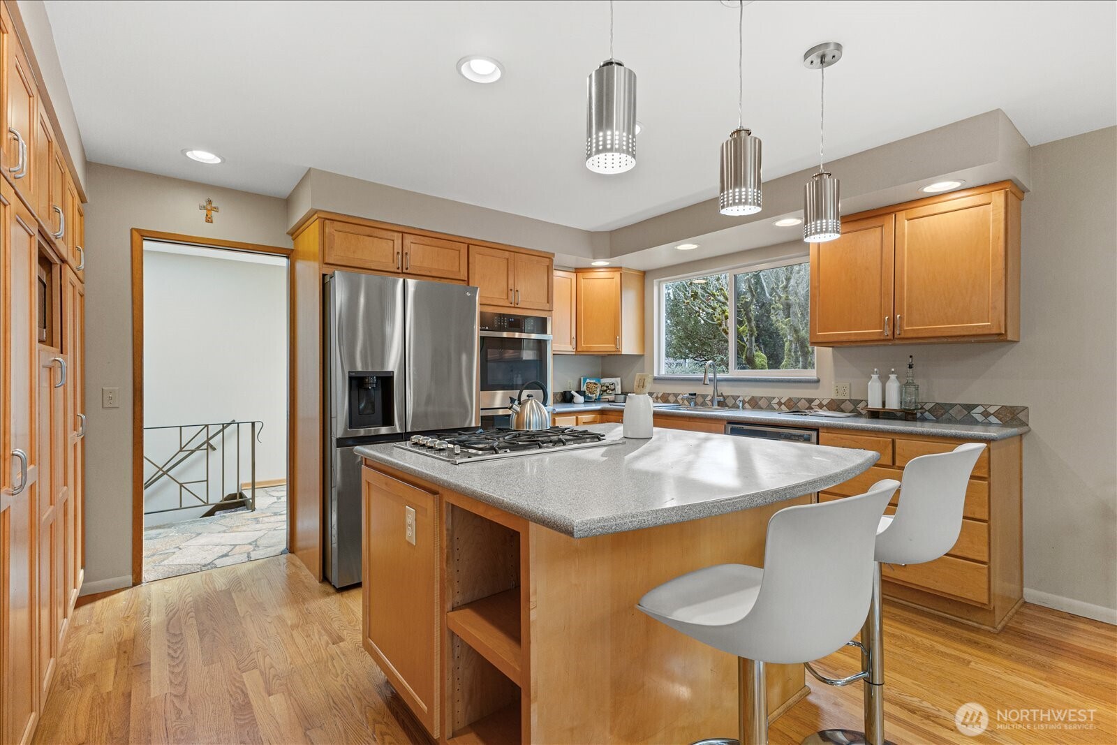 6520 Northeast 60th Street Seattle, WA 98115 - Photo 15 of 40 a kitchen with stainless steel appliances granite countertop a sink a stove and a refrigerator