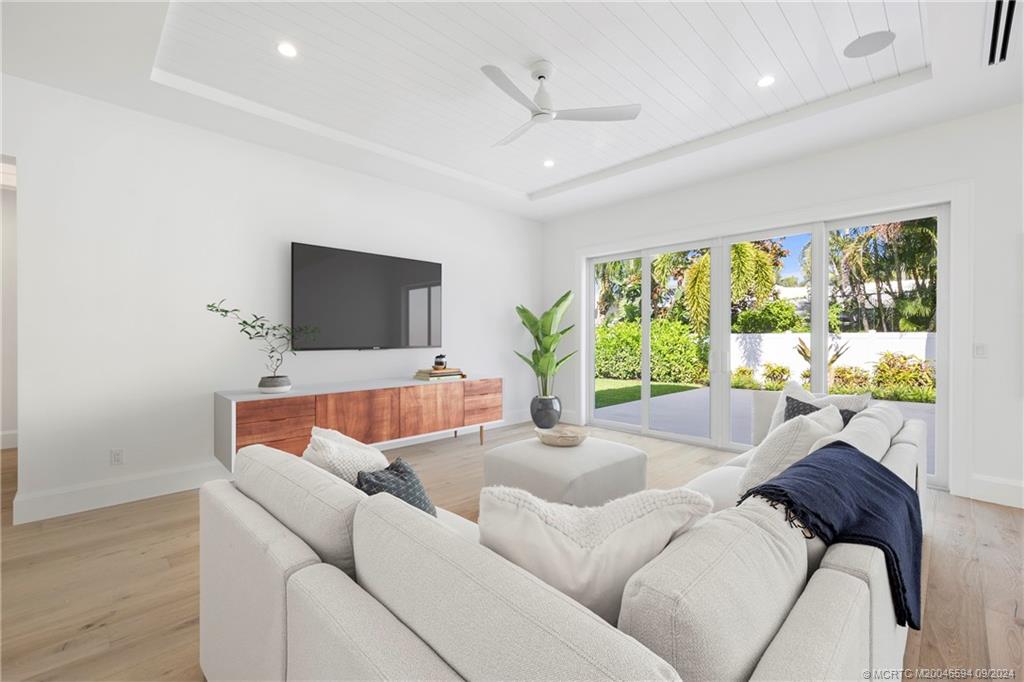 180 Beacon Lane Jupiter, FL 33469 - Photo 11 of 63 a living room with furniture and a flat screen tv