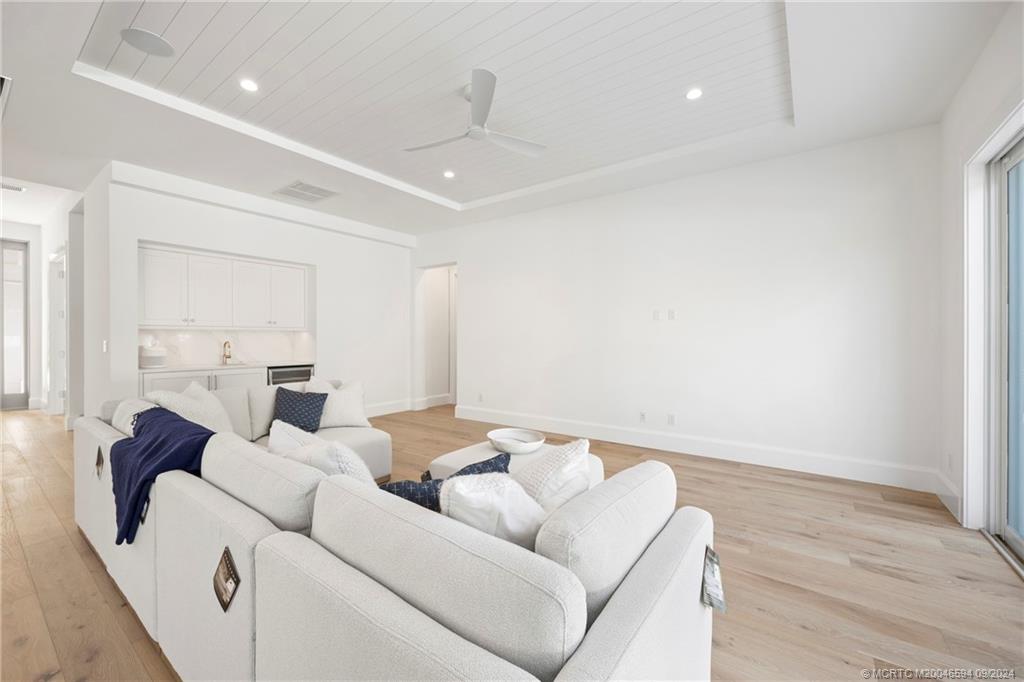180 Beacon Lane Jupiter, FL 33469 - Photo 12 of 63 a living room with furniture and a wooden floor