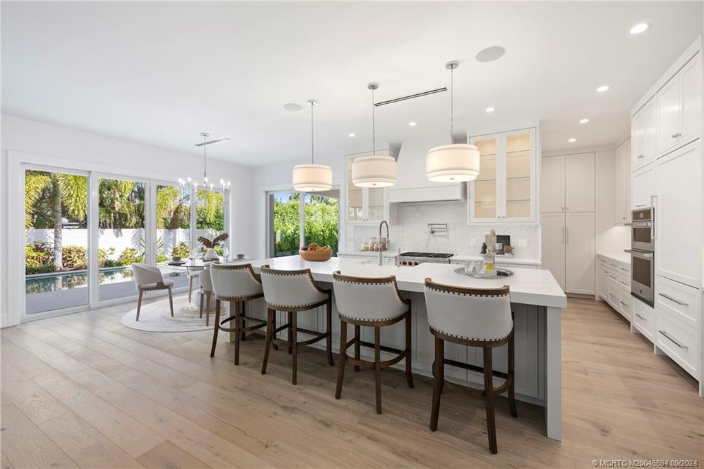 180 Beacon Lane Jupiter, FL 33469 - Photo 14 of 63 a large kitchen with a table and chairs
