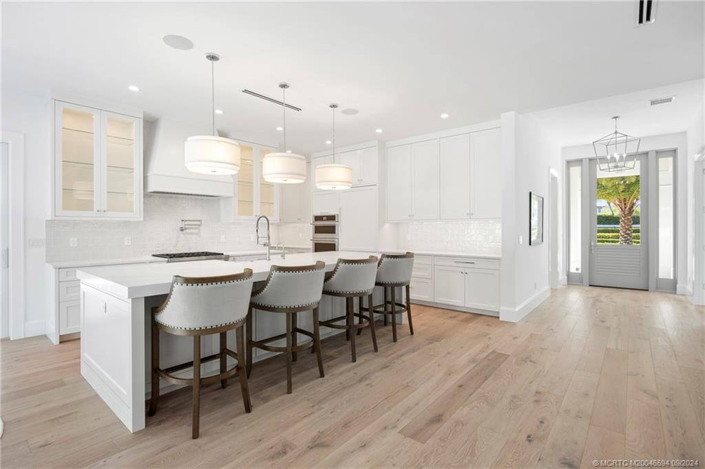 180 Beacon Lane Jupiter, FL 33469 - Photo 16 of 63 a large kitchen with a table and chairs