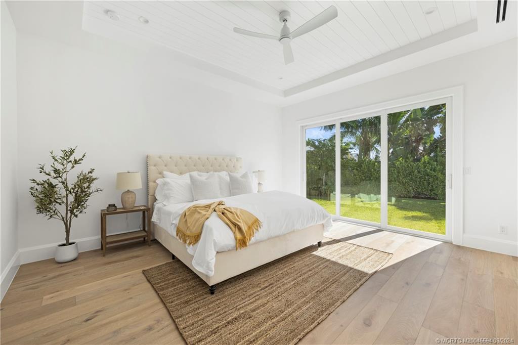 180 Beacon Lane Jupiter, FL 33469 - Photo 17 of 63 a bedroom with a bed and a large window