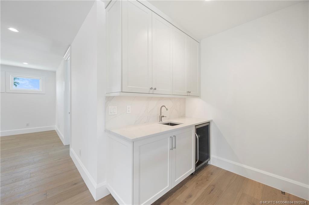 180 Beacon Lane Jupiter, FL 33469 - Photo 37 of 63 a view of a kitchen with white cabinets