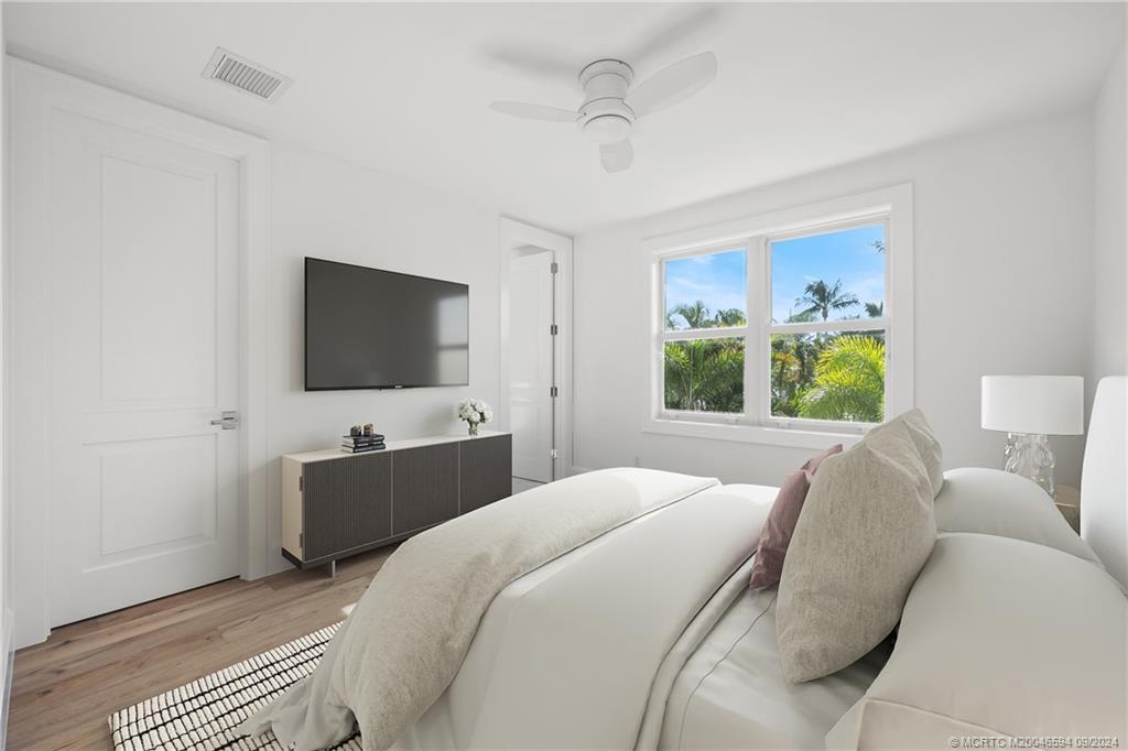 180 Beacon Lane Jupiter, FL 33469 - Photo 38 of 63 a bedroom with a bed and a flat screen tv