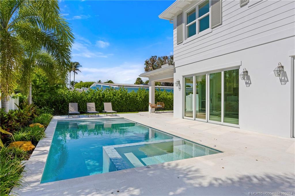 180 Beacon Lane Jupiter, FL 33469 - Photo 56 of 63 a view of a house with sitting area and garden