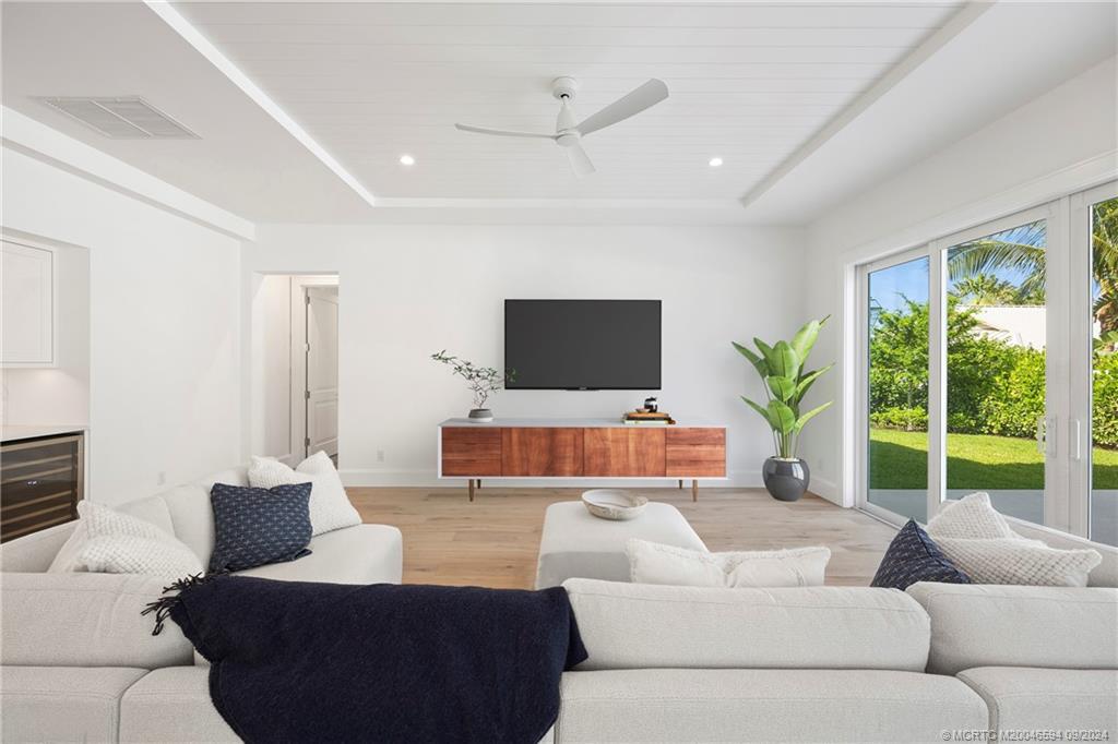 180 Beacon Lane Jupiter, FL 33469 - Photo 10 of 63 a living room with furniture and a flat screen tv