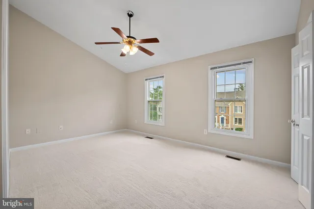 a bedroom with a large bed and potted plant