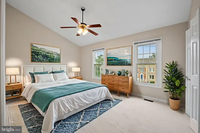 a view of an empty room and chandelier fan