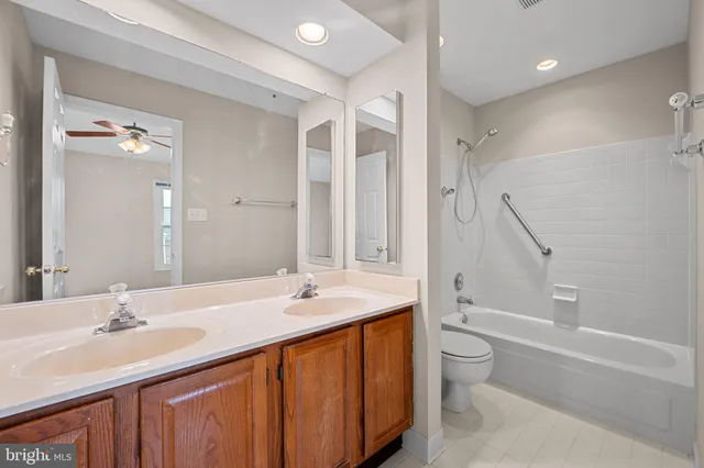 an empty room with ceiling fan and window