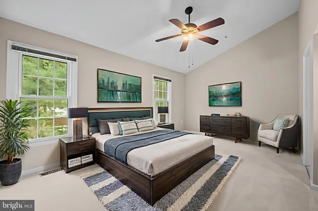 a view of an empty room with a ceiling fan and window