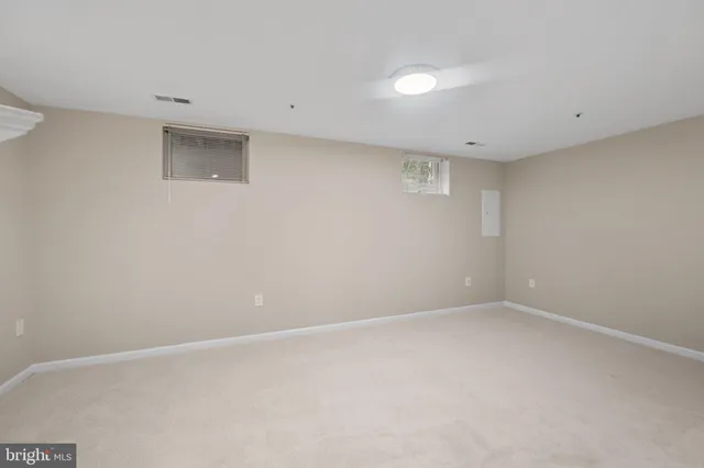 a view of empty room with a fireplace