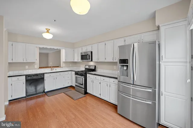 a kitchen with granite countertop stainless steel appliances and wooden cabinets