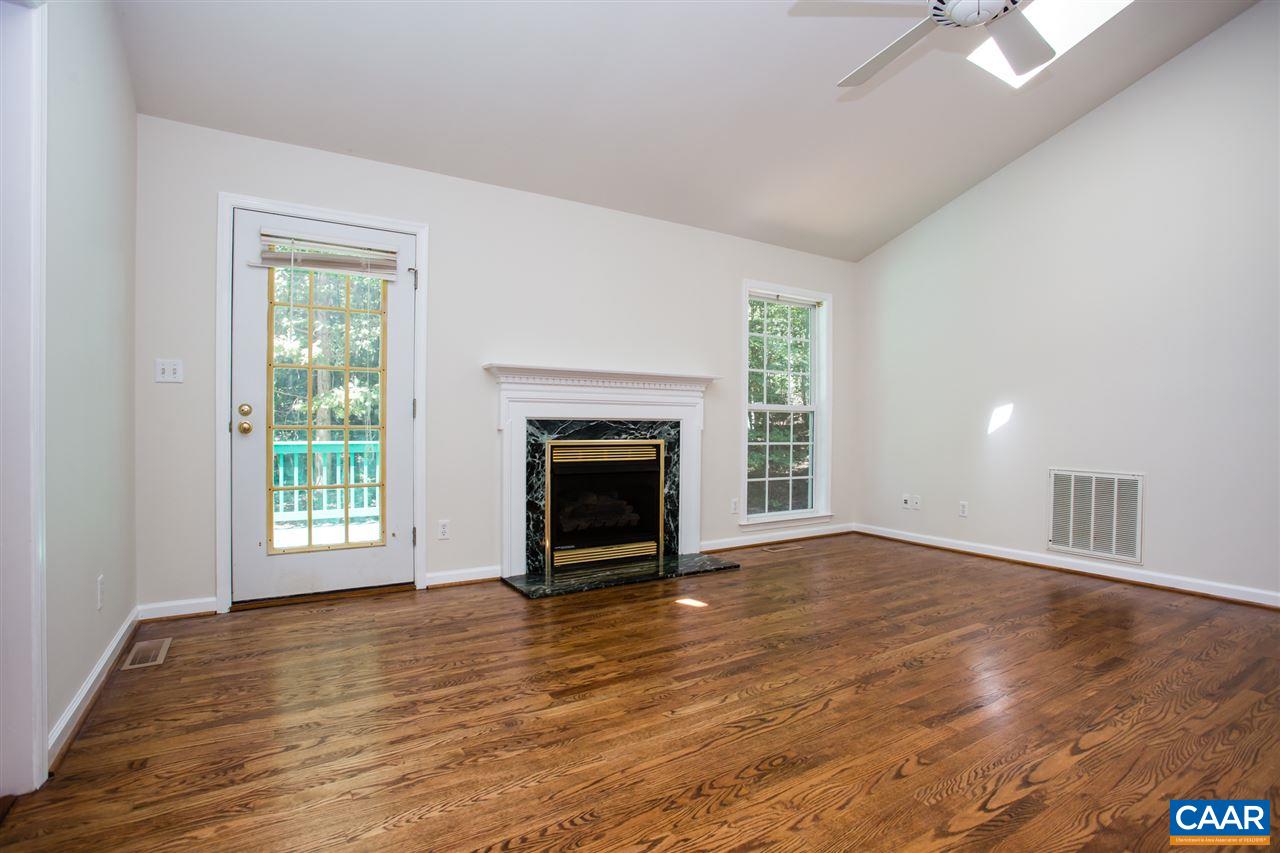 391 Rudolph Street Ruckersville, VA 22968 - Photo 6 of 31 an empty room with wooden floor fireplace and windows
