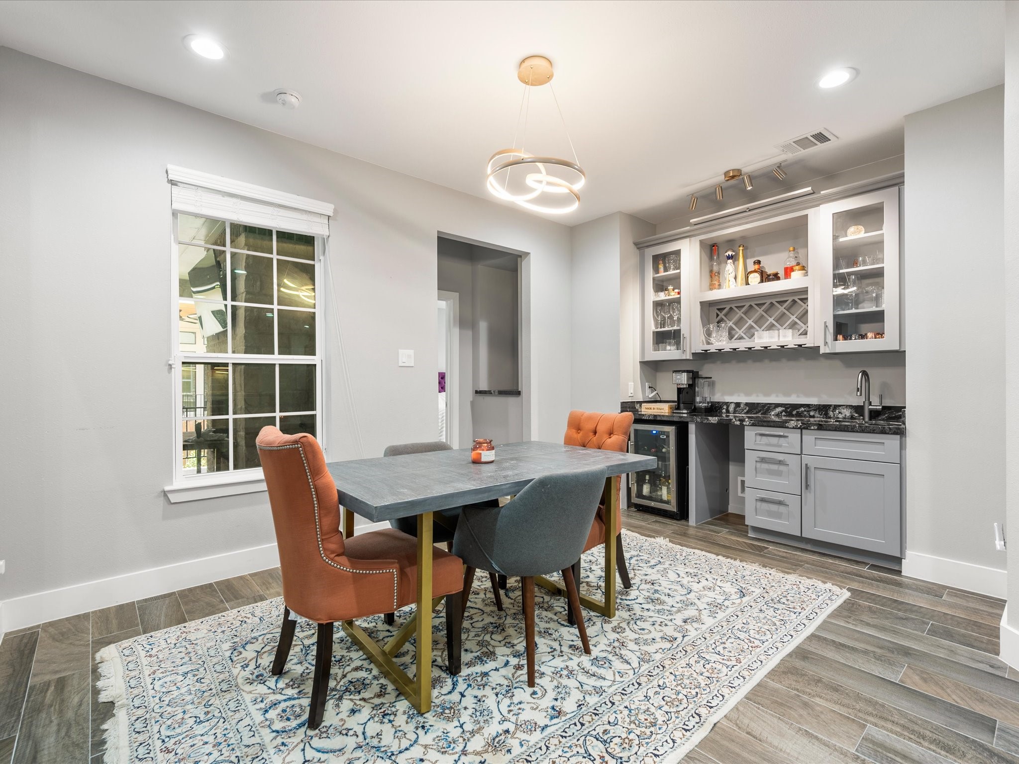6207 Graff Net Court Spring, TX 77379 - Photo 16 of 48 Elegant yet functional, the dining room offers a beautiful setting for entertaining with a convenient wet bar adding an extra touch of sophistication.