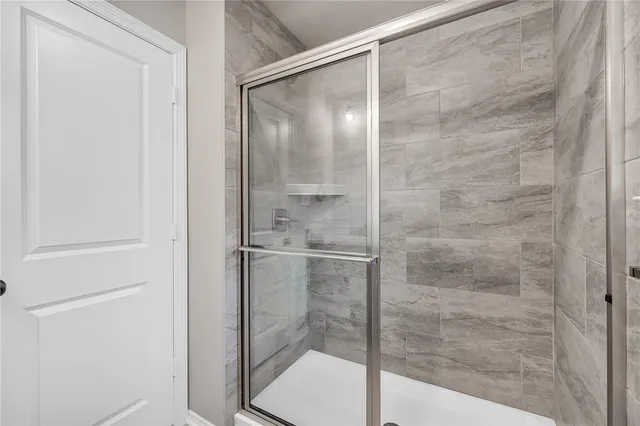 a bathroom with a glass shower door