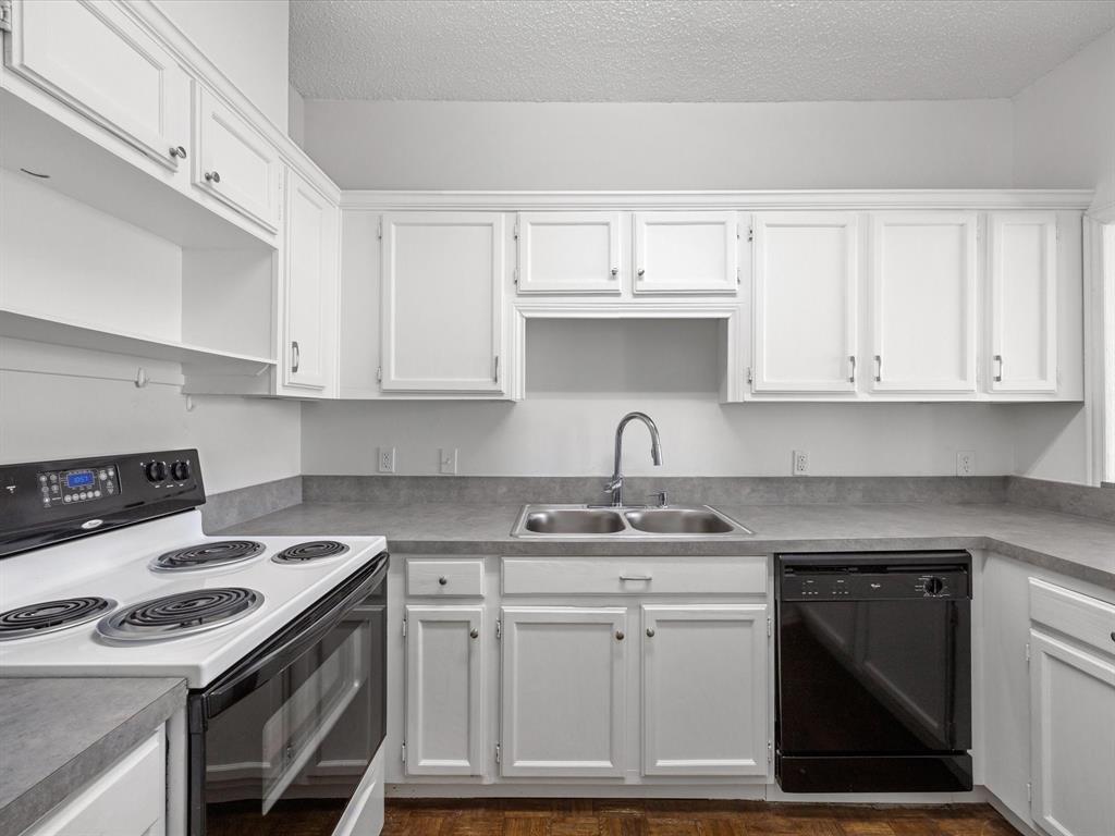 5310 Keller Springs Road, Unit 332 Dallas, TX 75248 - Photo 11 of 39 Kitchen featuring black appliances, white cabinets, open shelves, a textured ceiling, and light countertops