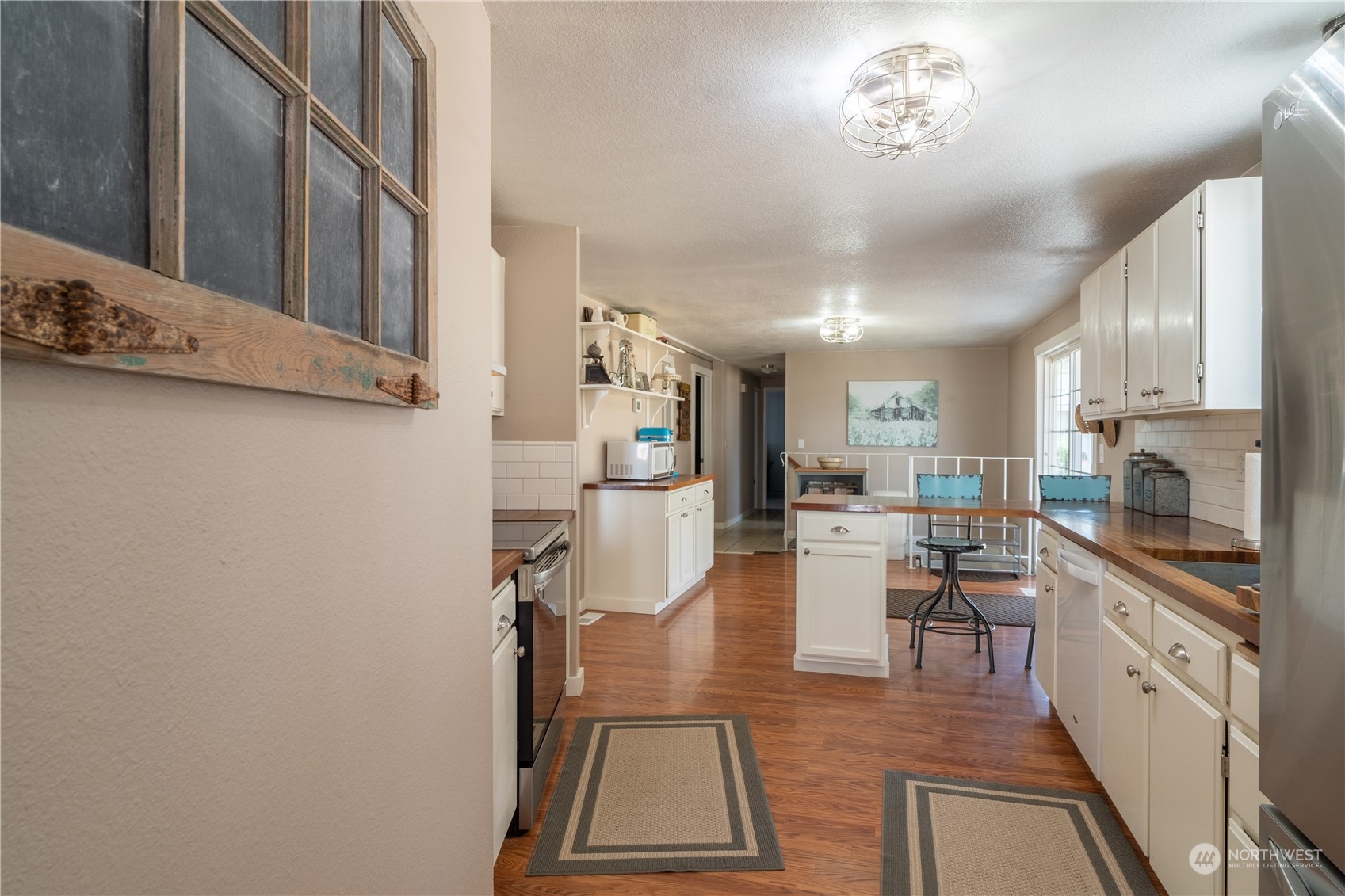 102 East Herman Road Lind, WA 99341 - Photo 12 of 40 a view of a kitchen with kitchen island stainless steel appliances refrigerator stove microwave and cabinets