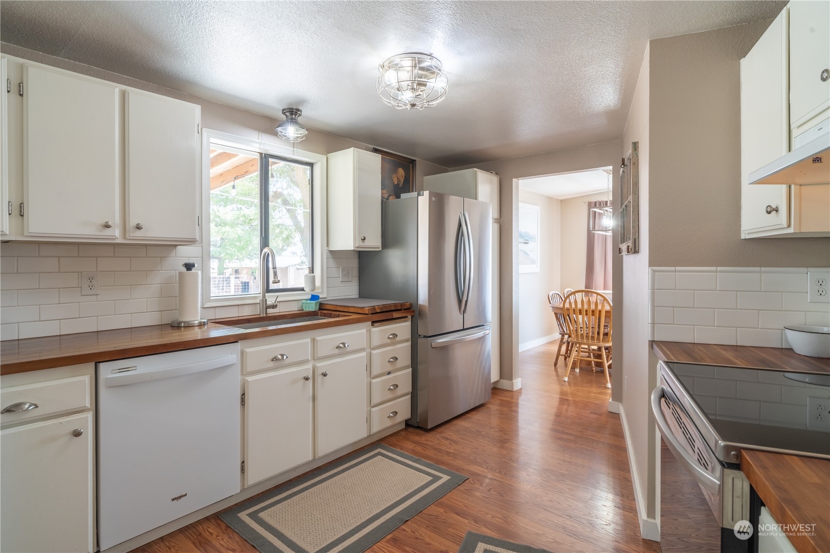 102 East Herman Road Lind, WA 99341 - Photo 13 of 40 a kitchen with stainless steel appliances a refrigerator a sink a stove a table and chairs