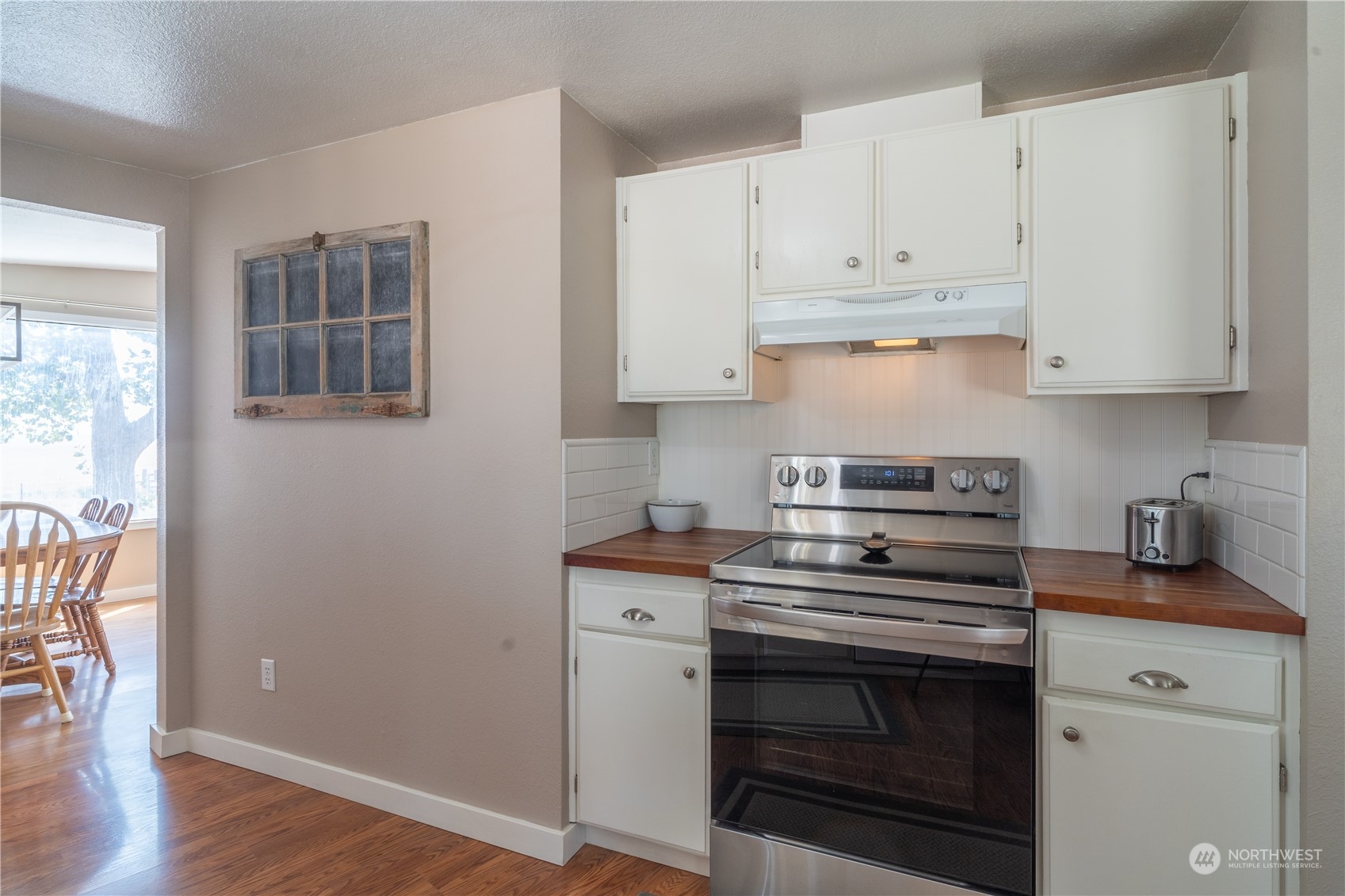 102 East Herman Road Lind, WA 99341 - Photo 14 of 40 a kitchen with granite countertop white cabinets and stainless steel appliances