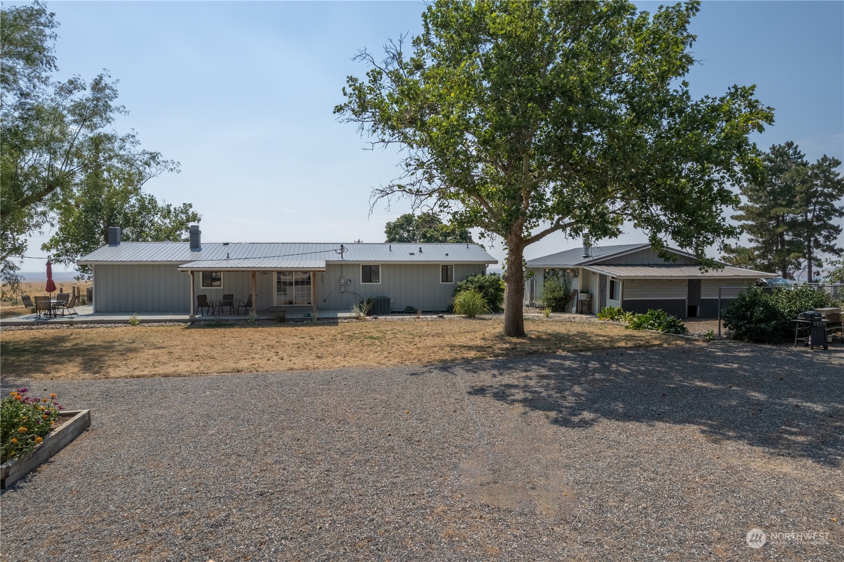 102 East Herman Road Lind, WA 99341 - Photo 4 of 40 a front view of a house with a yard and a garage