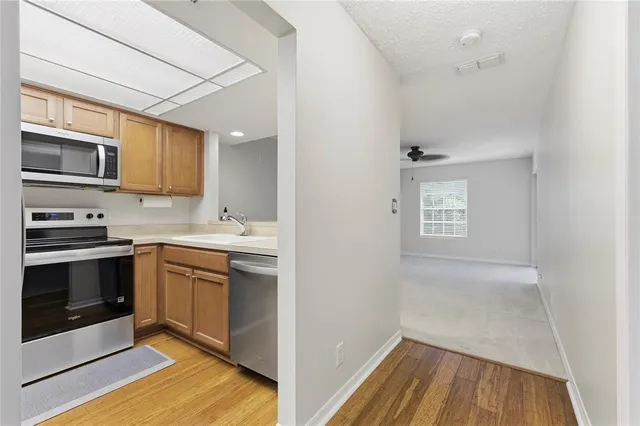 a kitchen with stainless steel appliances granite countertop a stove and a microwave