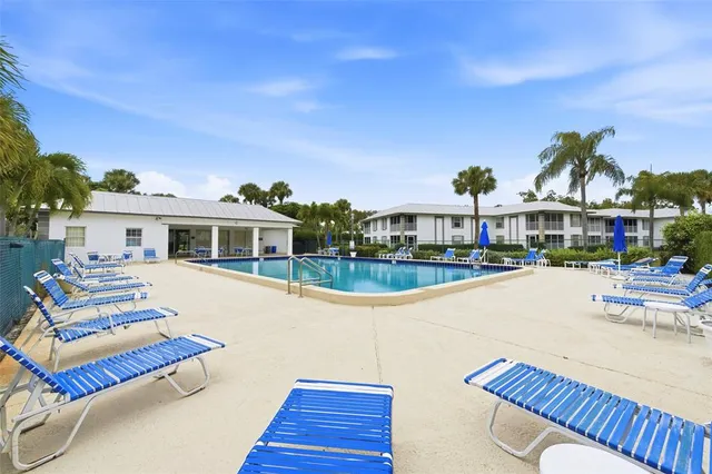 a view of a house with swimming pool and sitting area
