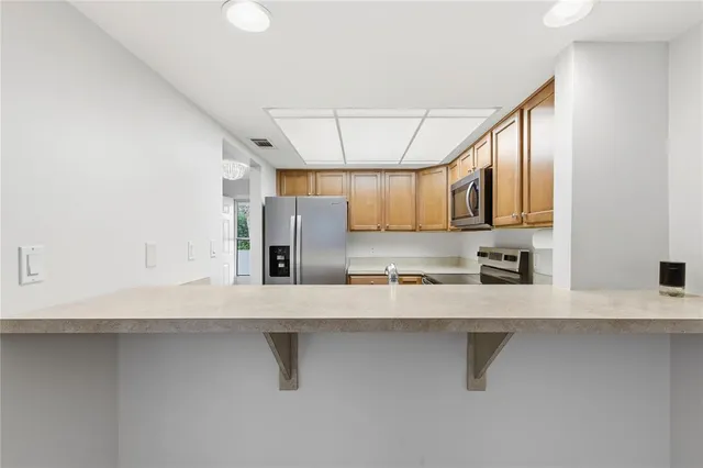 a view of a kitchen with a sink and a window