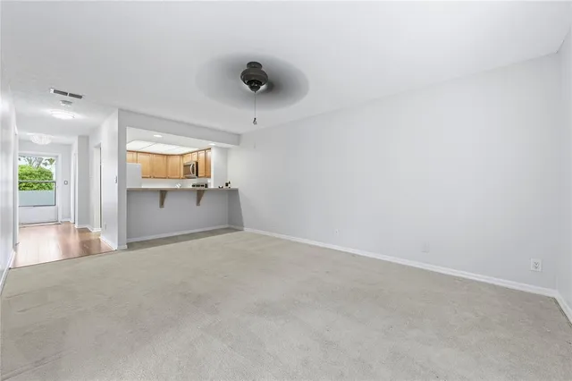 an empty room with a kitchen and a sink