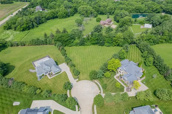 an aerial view of a house with a garden and lake view