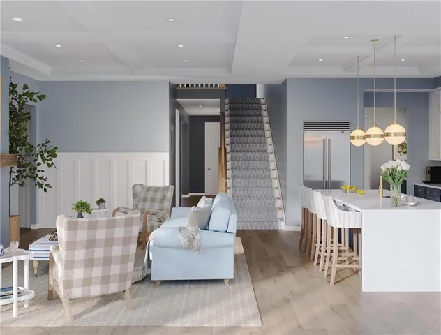 a living room with furniture flowerpot and a potted plant