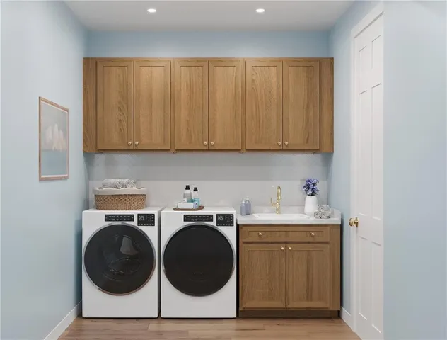 a utility room with sink dryer and washer