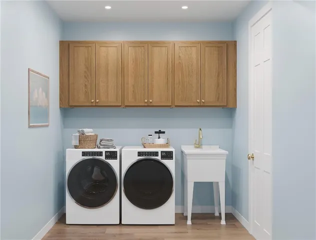 a utility room with sink dryer and washer