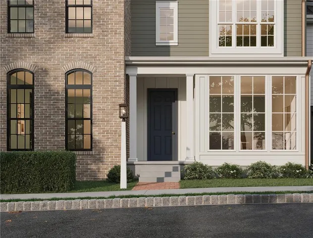 front view of a brick house with a small yard