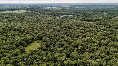 an aerial view of a houses with a yard