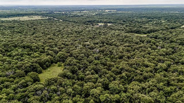 an aerial view of a houses with a yard