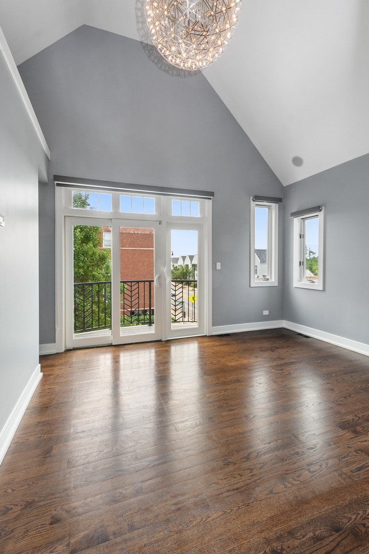 3700 North Kenneth Avenue Chicago, IL 60641 - Photo 12 of 29 an empty room with wooden floor and windows