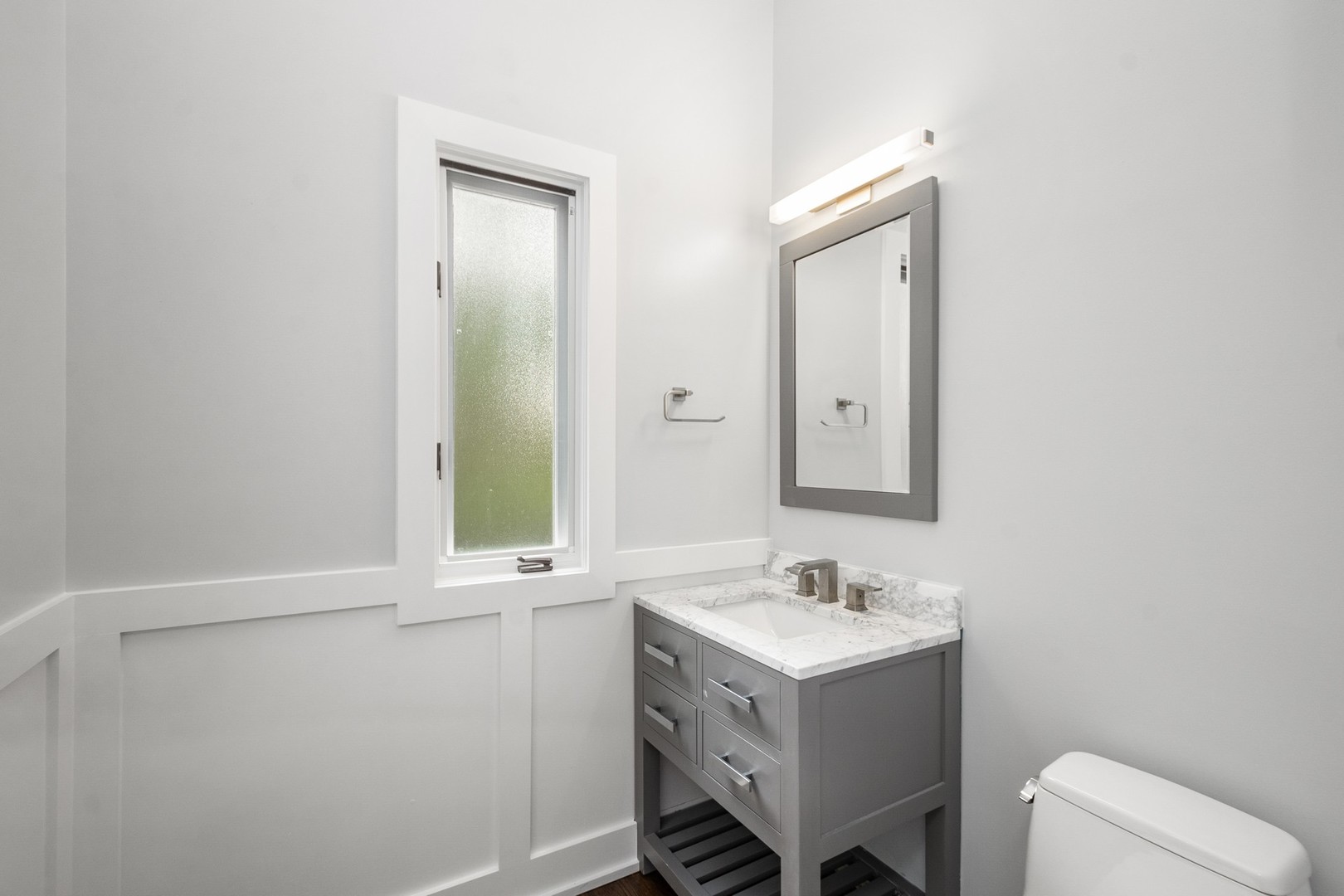 3700 North Kenneth Avenue Chicago, IL 60641 - Photo 21 of 29 a bathroom with a sink vanity a toilet and mirror
