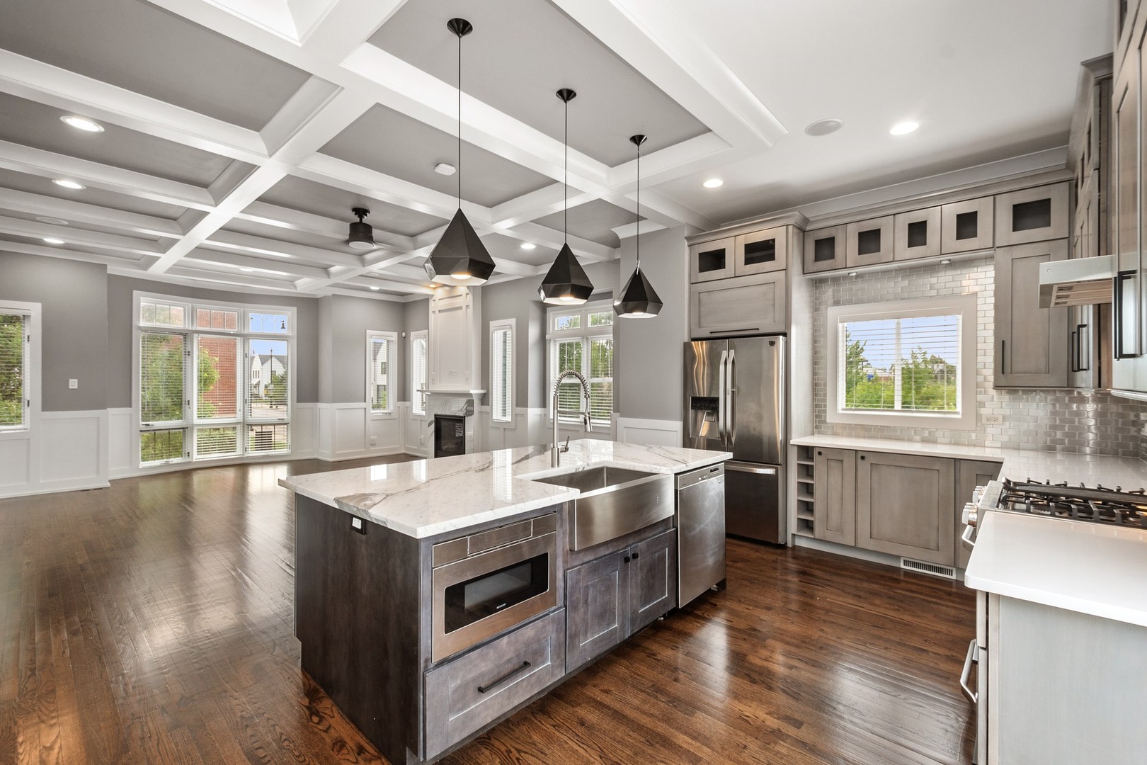 3700 North Kenneth Avenue Chicago, IL 60641 - Photo 8 of 29 a large white kitchen with stainless steel appliances granite countertop a large stove a sink dishwasher and cabinets with wooden floor