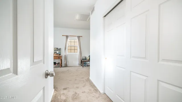 a view of a hallway with wooden floor and entryway