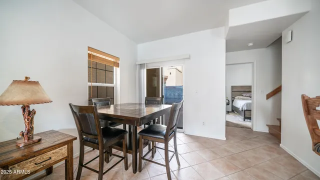a view of a dining room with furniture and a chandelier