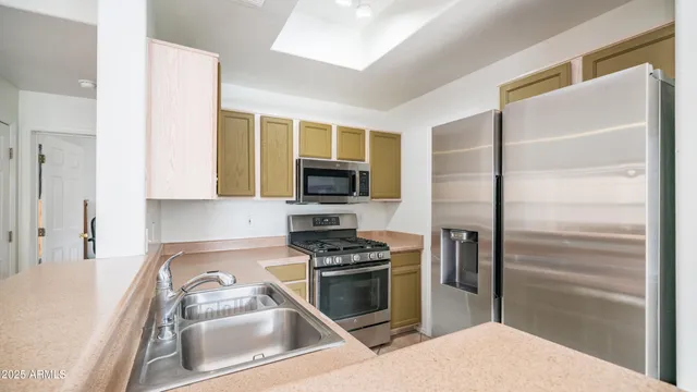 a kitchen with a refrigerator stove and sink