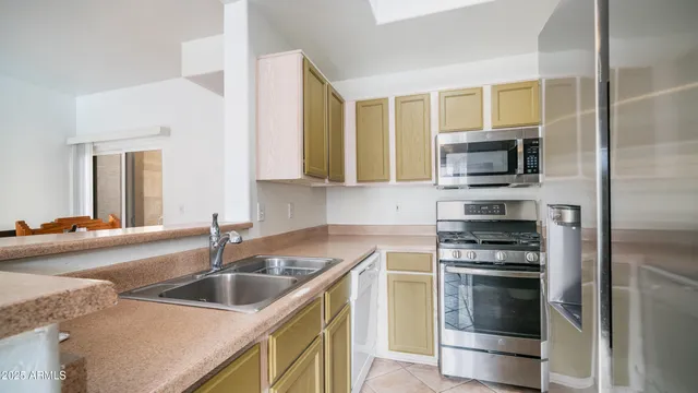 a kitchen that has a sink and a stove top oven
