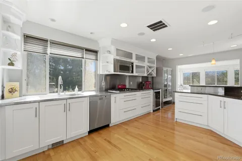 a kitchen with stainless steel appliances granite countertop a sink and cabinets