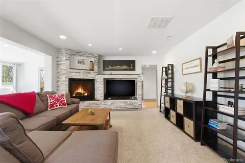 a kitchen with stainless steel appliances granite countertop a sink a stove and white cabinets
