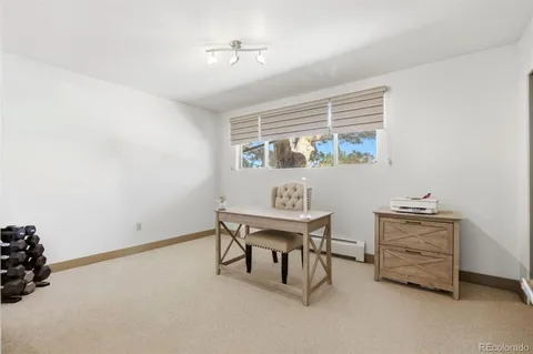 a bathroom with a granite countertop toilet sink and mirror