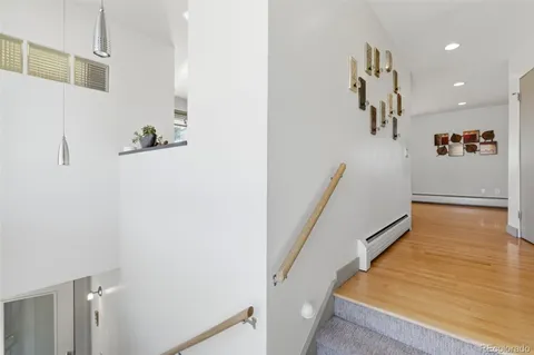 a kitchen with stainless steel appliances kitchen island granite countertop a table and chairs in it