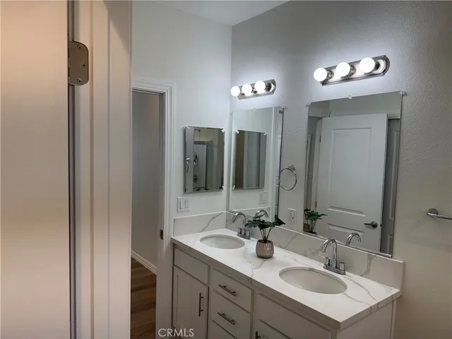 a bathroom with a sink double vanity and a mirror
